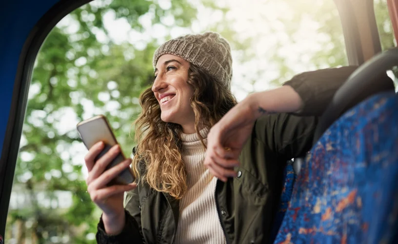 A female bus passenger using her phone