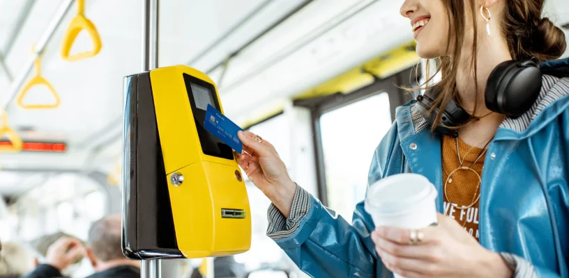 Woman paying for travel on bus using card